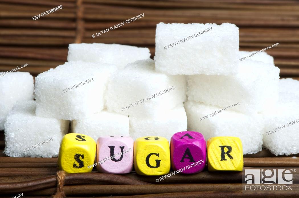 Imagen: Sugar lumps and word sugar. Multicolored cubes.