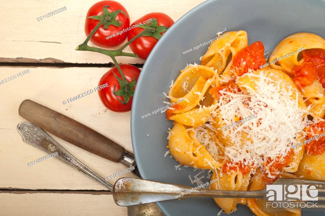 Stock Photo: Italian snail lumaconi pasta with ripe cherry tomatoes sauce ingredients.
