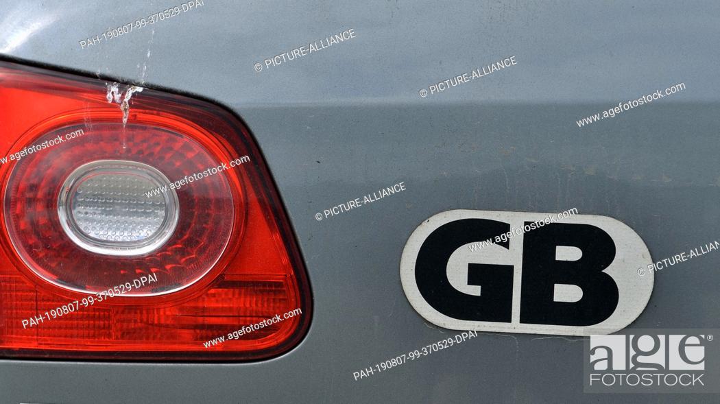 Stock Photo: 12 July 2019, Great Britain, St Ives: The country code GB for Great Britain, Great Britain sticks on a car. Photo: Hendrik Schmidt/dpa-Zentralbild/ZB.