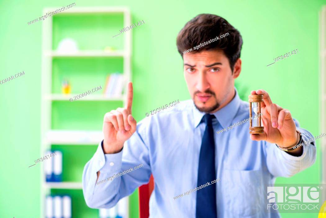 Stock Photo: Young male architect working at the project.