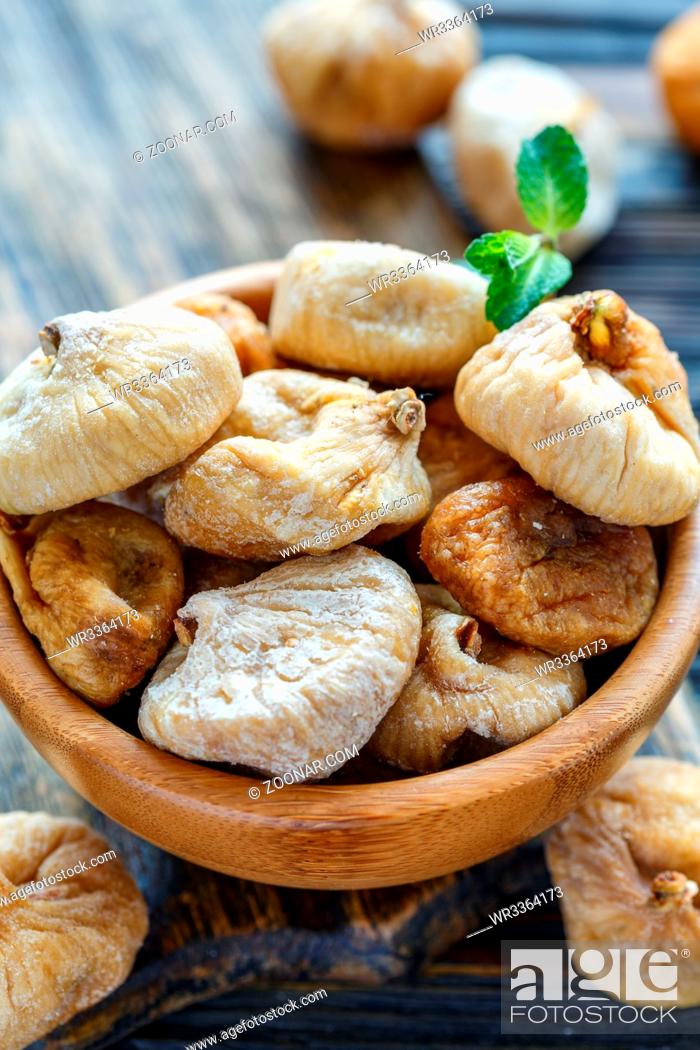 Stock Photo: Delicious dried figs in a wooden bowl closeup, selective focus.