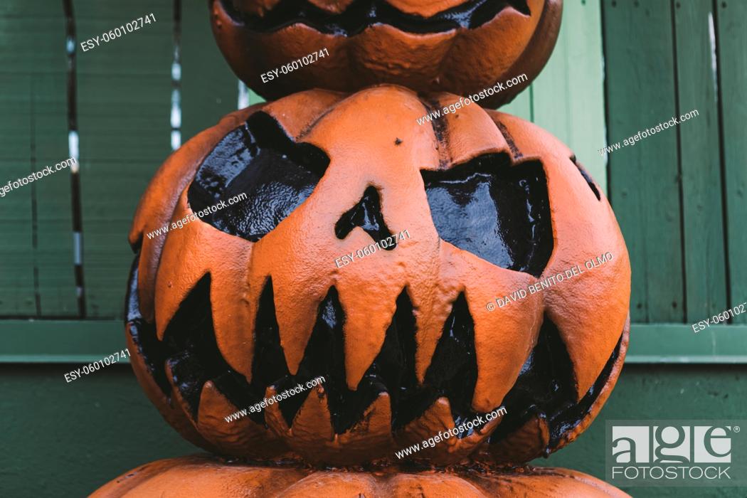 Stock Photo: A Halloween decorative dark colored Jack-o-Lantern pumpkin on the street. Halloween and carnival celebration concept.