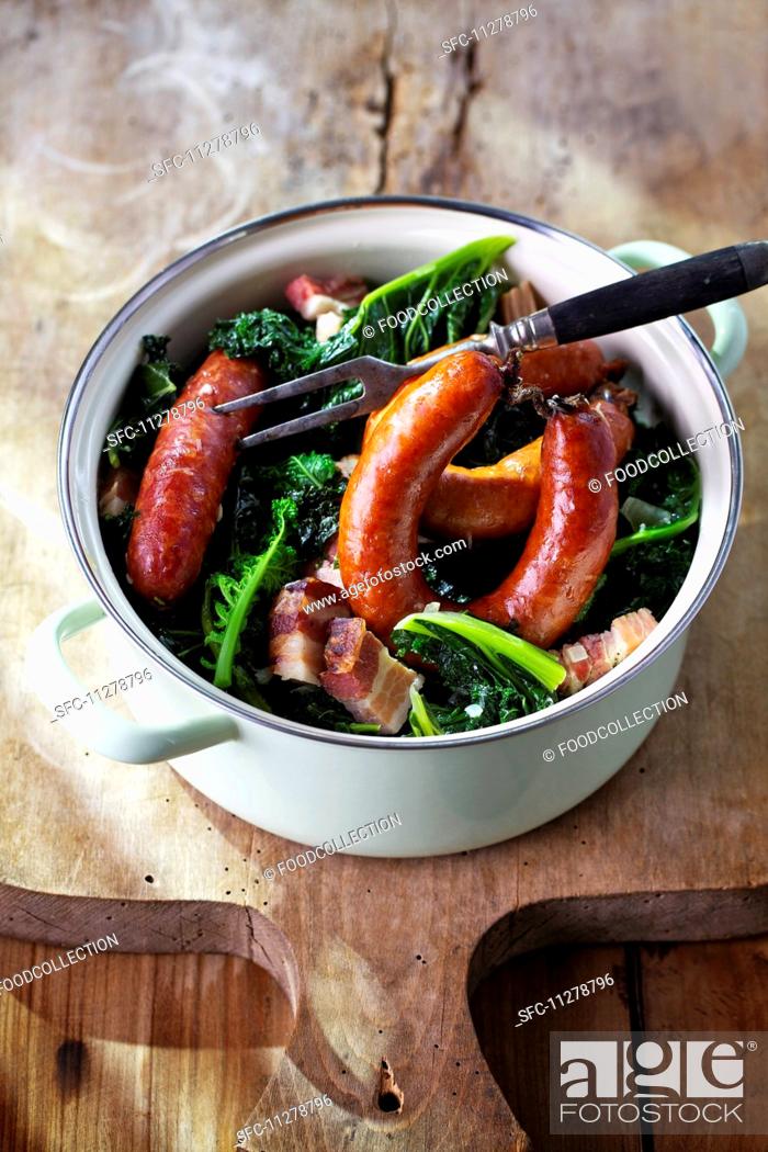 Stock Photo: Green kale with Pinkel (smoked sausage from bacon, groats and spices) in a pot.