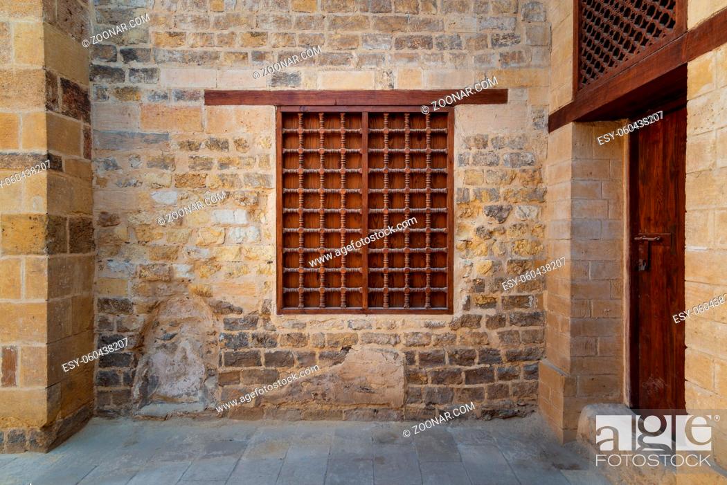 Stock Photo: Mamluk era wooden closed window with wooden ornate grid over stone bricks wall, Tekkeyet Al Bustami, Dar El Labana district, Cairo, Egypt.