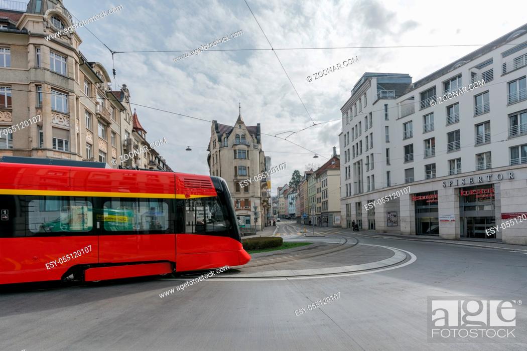 Stock Photo: St. Gallen, SG / Switzerland - April 8, 2019: the historic Appenzeller train rounds the Spisertor in downtown St. Gallen on ist way out of the city.