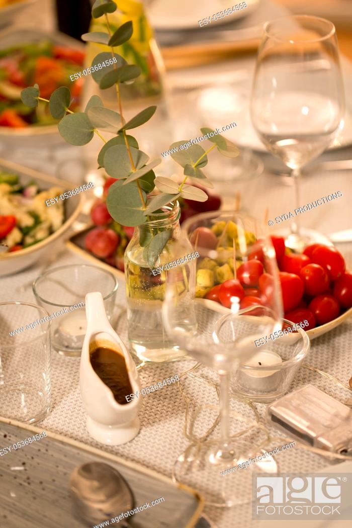 Stock Photo: table served with plates, wine glasses and food.