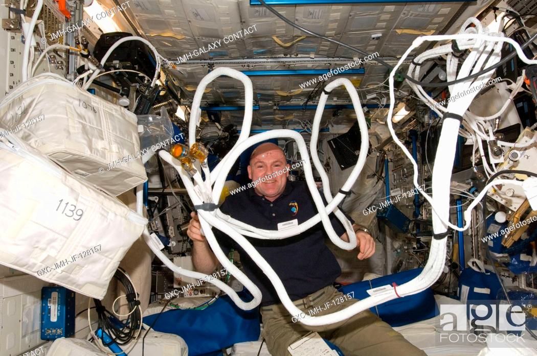 Stock Photo: European Space Agency astronaut Andre Kuipers, Expedition 31 flight engineer, works with Anomalous Long Term Effects on Astronauts (ALTEA) equipment in the.