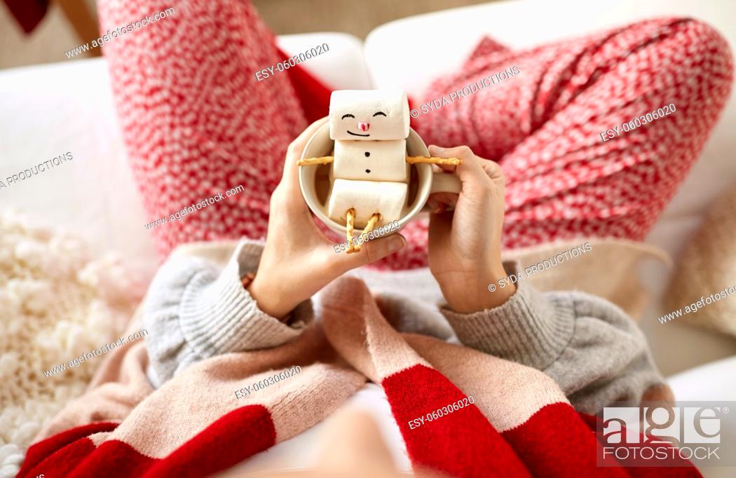 Stock Photo: hands with marshmallow snowman in mug on christmas.
