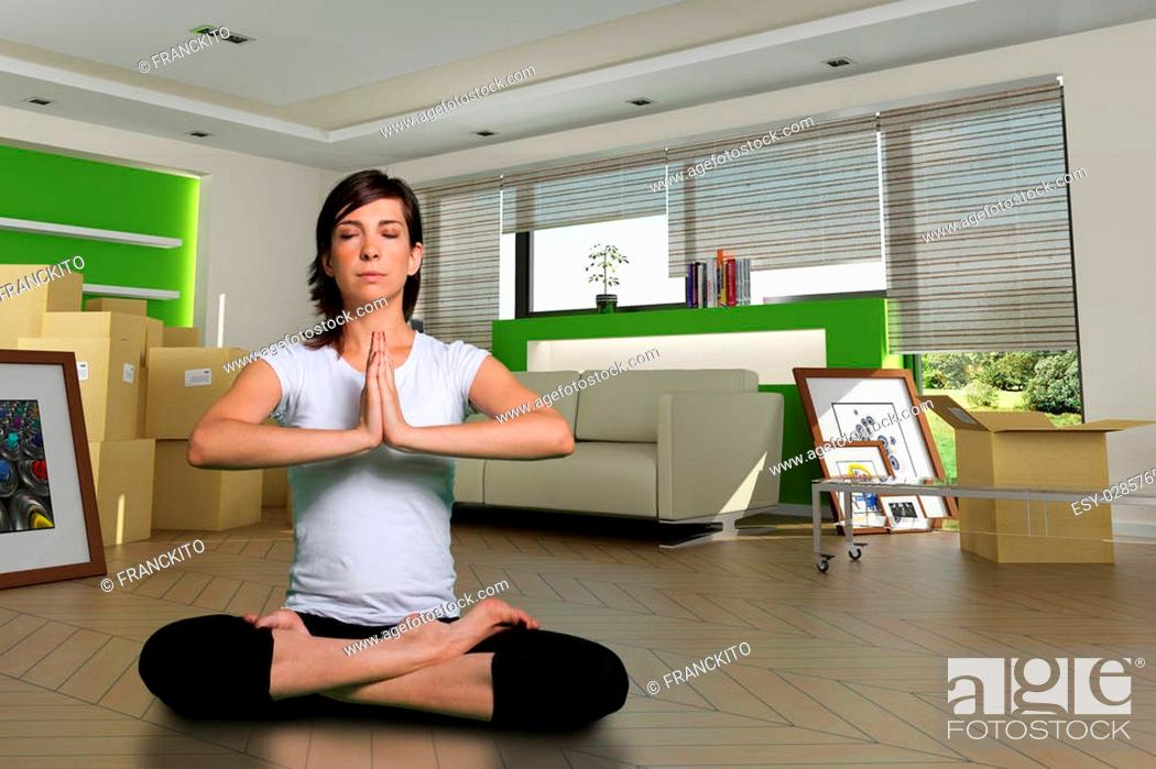 Stock Photo: Woman in lotus position in her new home. The images of the pictures are mine, and the label information is made up, so no copyright issue.