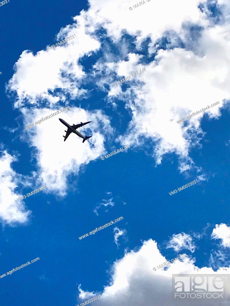 Stock Photo: Airplane flying on cloudy sky.