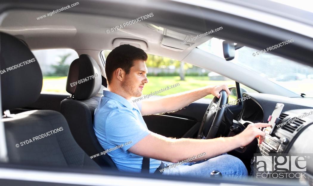 Stock Photo: man or driver driving car and using gps navigator.