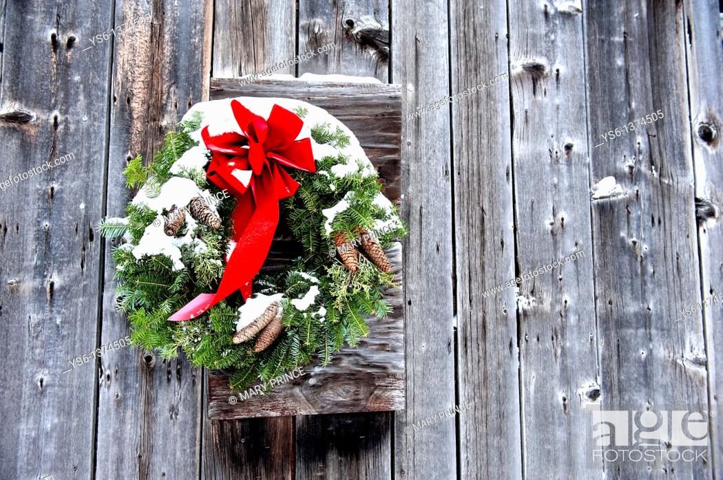 Stock Photo: Snowy Christmas Wreath on Side of Barn.