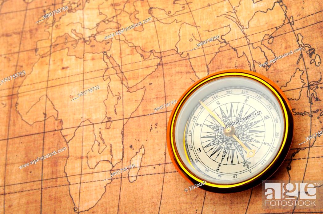 Imagen: Compass on old map.