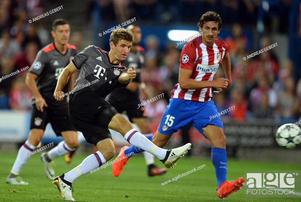 Stock Photo: Munich's Thomas Mueller (l) and Atletico's Stefan Savic (r) in action during the Champions League Group D soccer match between Atletico Madrid and Bayern Munich.