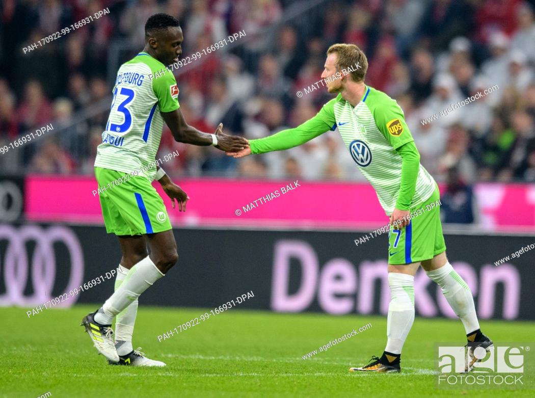 Stock Photo: VfL Wolfsburg's Josuha Guilavogui (L) congratulates Maximilian Arnold on his 2-1 goal during the German Bundesliga soccer match between Bayern Munich and VfL.