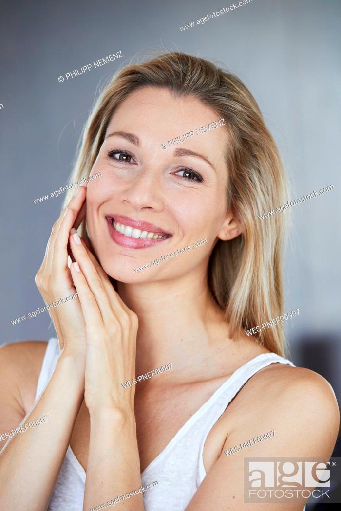 Stock Photo: Portrait of smiling blond woman.