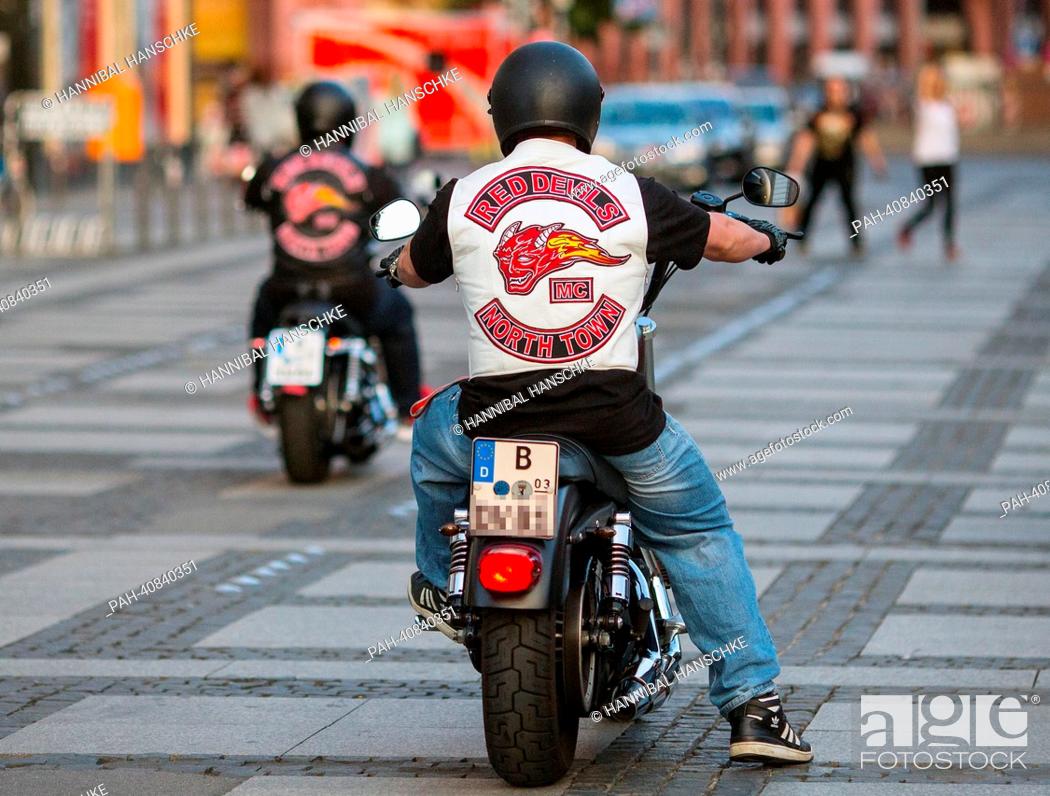 Stock Photo: Bikers of biker club 'Red Devils' drive their motorcycles on Alexanderplatz in Berlin, Germany, 02 July 2013. The 'Red Devils' are considered supporters of.