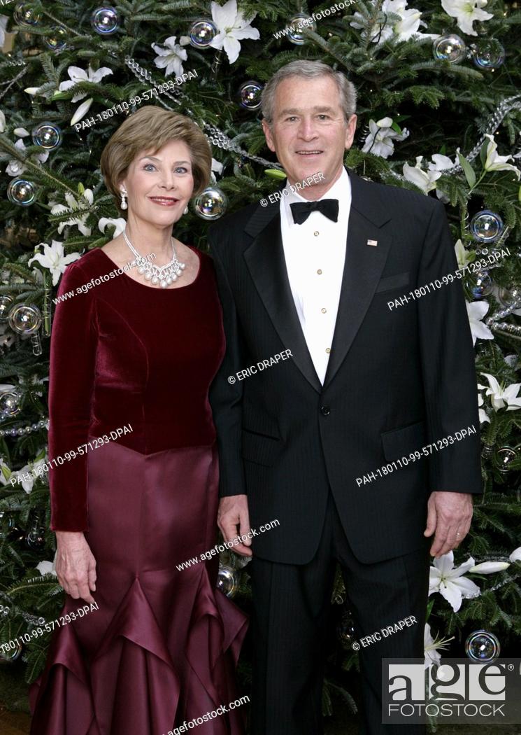 Stock Photo: United States President George W. Bush and first lady Laura Bush pose for their Official Holiday Portrait near the White House Christmas tree in the Blue Room.