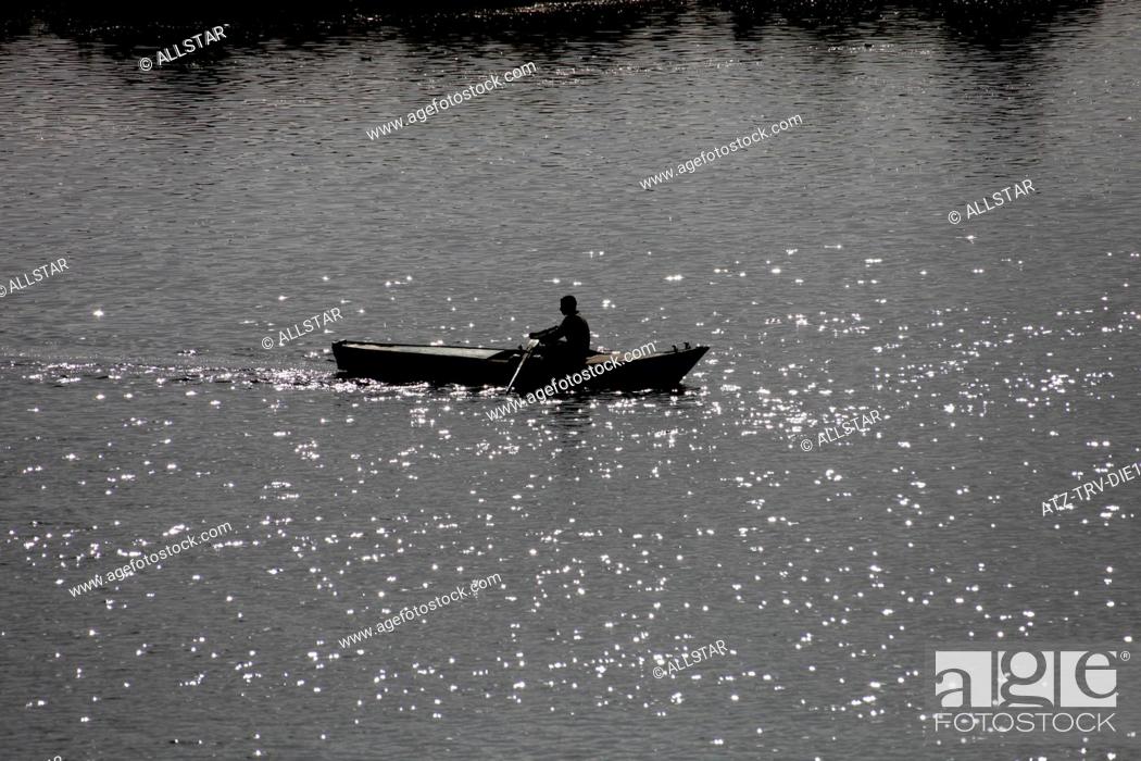 Stock Photo: MUSLIM MAN IN ROWING BOAT; RIVER NILE, EGYPT; 09/01/2013.
