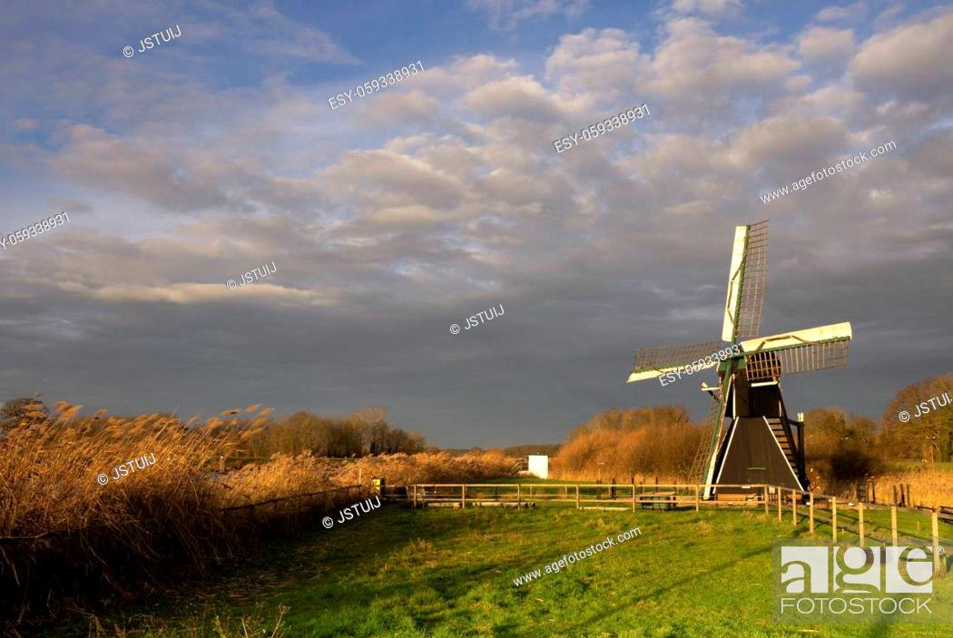 Stock Photo: The Follega windmill near the Dutch village Laag-Keppel seen under a heavy clouded sky.