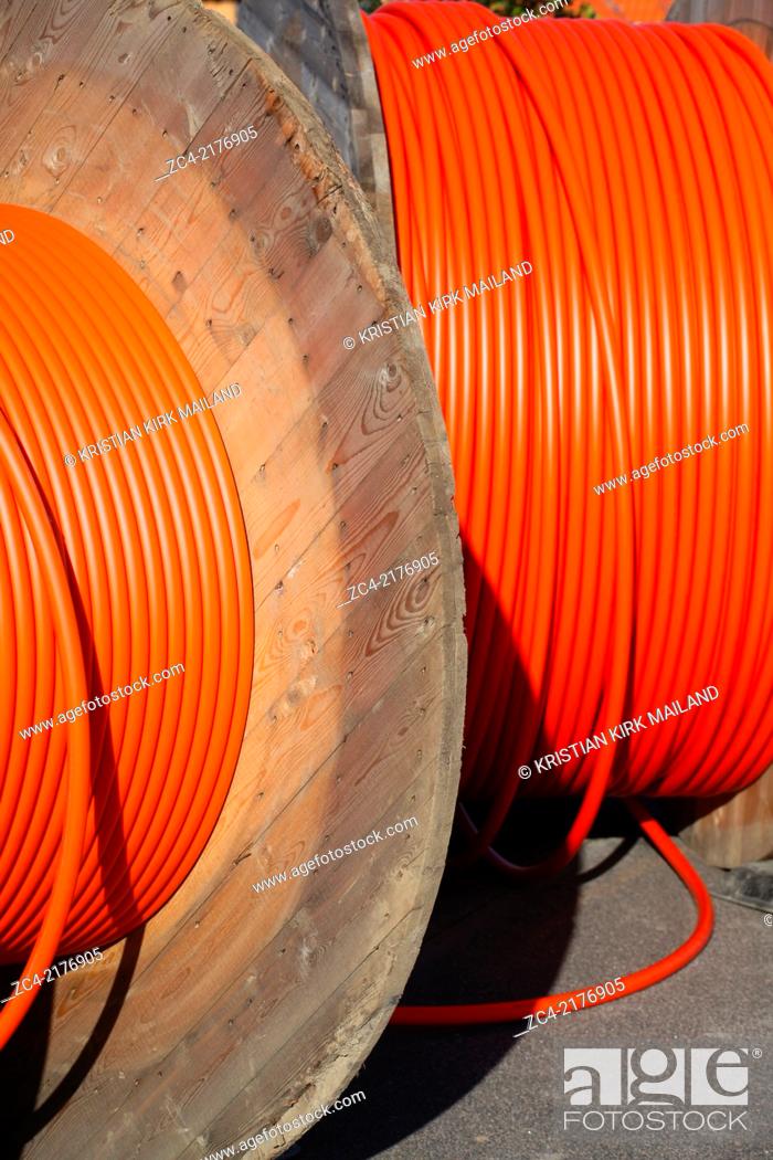 Stock Photo: Huge orange cable drums for optic fibre connections.