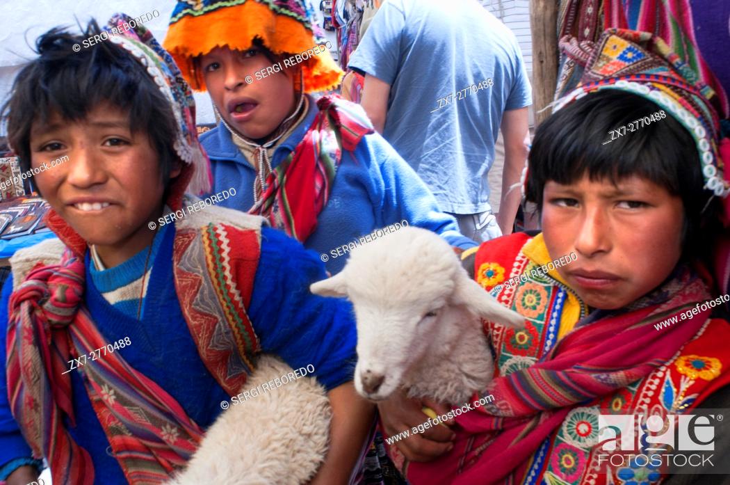 Stock Photo: Sacred Valley, Pisac, Peru. Children dressed in traditional costume in Pisac Sunday market day. Pisac. Sacred Valley. Pisac, or Pisaq in Quechua.