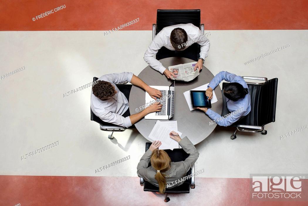 Stock Photo: Office workers taking work into breakroom.
