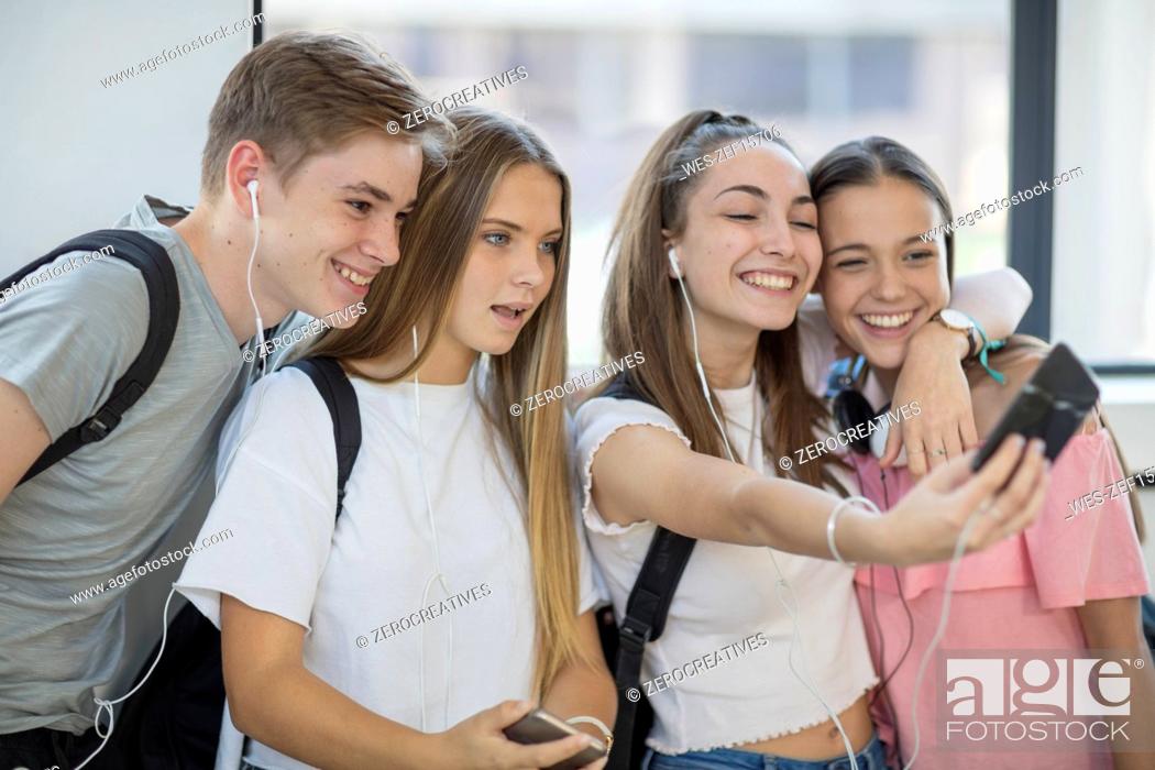 Stock Photo: Happy students taking a selfie in school.