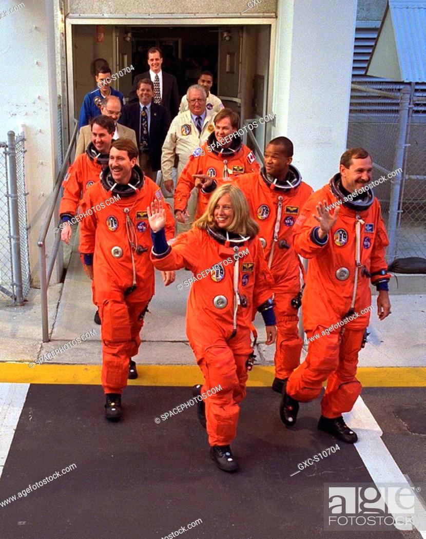 Stock Photo: 08/07/1997 -- The STS-85 flight crew greets a crowd of well-wishers as they walk out of the Operations and Checkout O&C Building for their ride to Launch Pad.