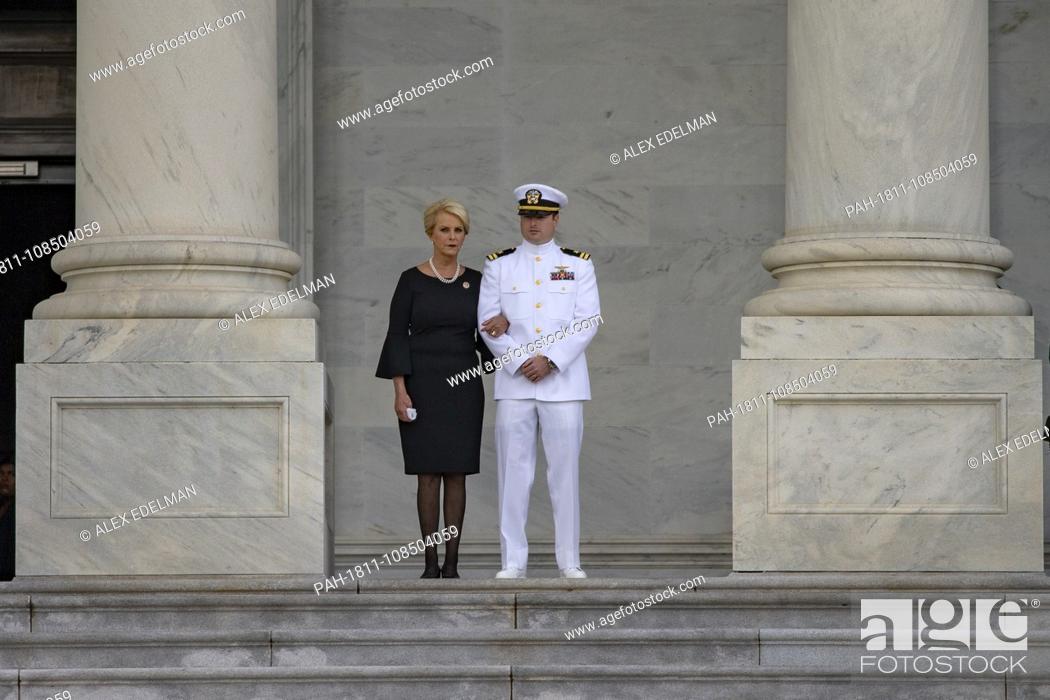 Stock Photo: Cindy McCain and Jack McCain, the wife and son of late Senator John McCain look on as a United States Military Honor Guard carries the casket of former Senator.