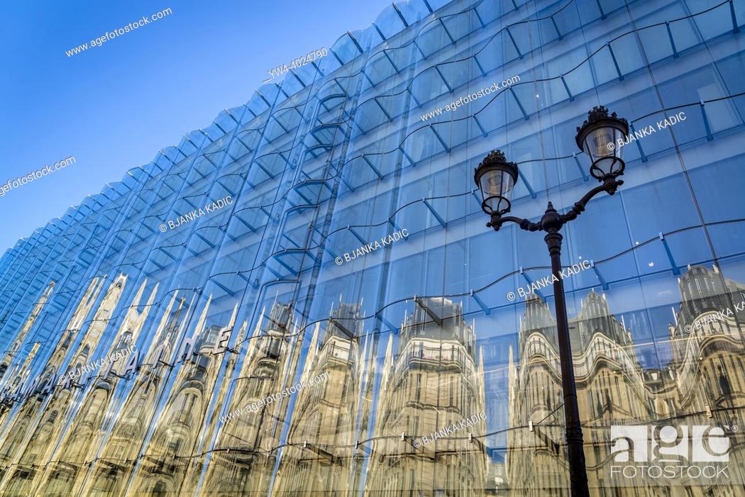 Stock Photo: Reflections in the new rippling glass facade on the La Samaritaine building, a department store built in Art Nouveau style, located in the first arrondissement.