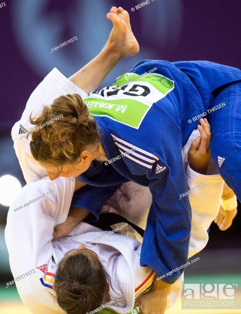 Stock Photo: Germanys Mareen Kraeh (blue) competes with Larisa Florian of Romania in the Women's -52kg Judo Women's Bronze Final A at the Baku 2015 European Games in Heydar.