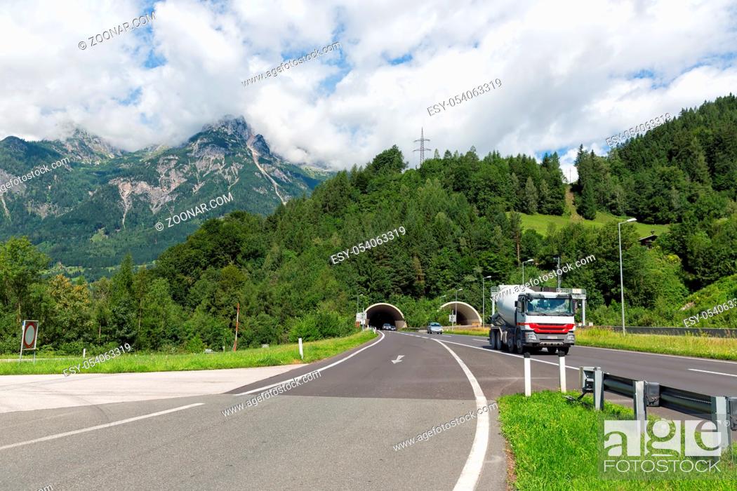 Stock Photo: Austrian highway A10 with car park near Hohenwerfen with traffic leaving a tunnel through the mountains.