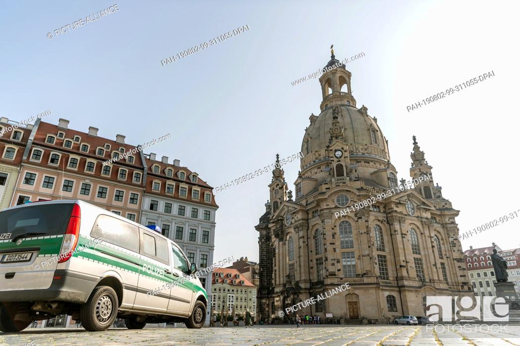Stock Photo: 11 June 2019, Saxony, Dresden: A police car is parked on the Neumarkt in front of the Frauenkirche. Photo: Robert Michael/dpa-Zentralbild/ZB.