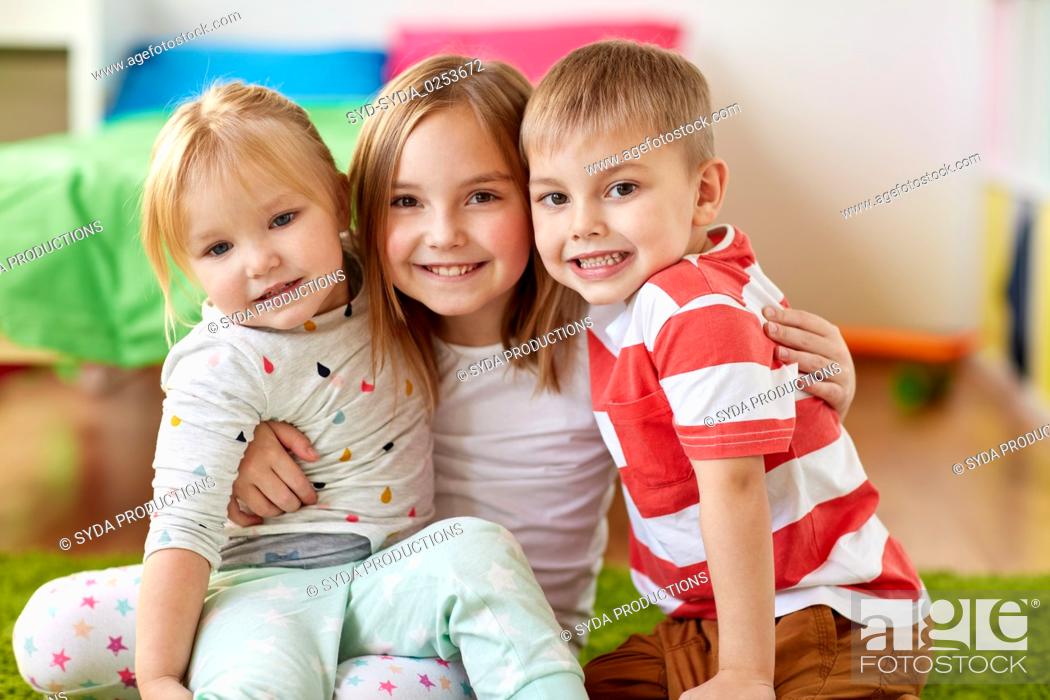 Stock Photo: happy little kids hugging at home.