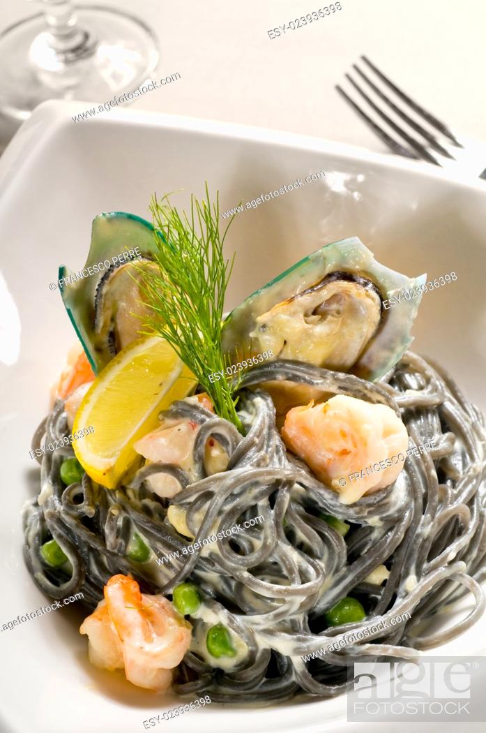 Stock Photo: fresh seafood black squid ink coulored spaghetti pasta tipycal italian food.
