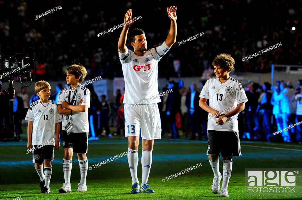 Stock Photo: German soccer player Michael Ballack bids farewell to his fans with his three sons during his final soccer match at the Red Bull Arena in Leipzig, Germany.
