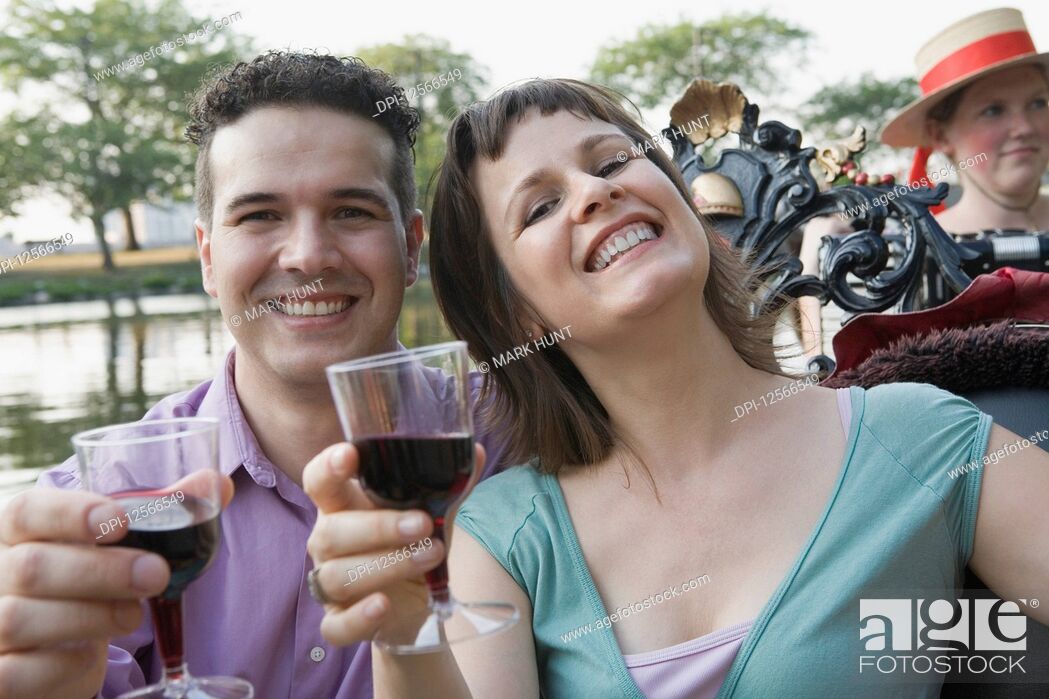 Stock Photo: Portrait of a mid adult couple holding glasses of wine.
