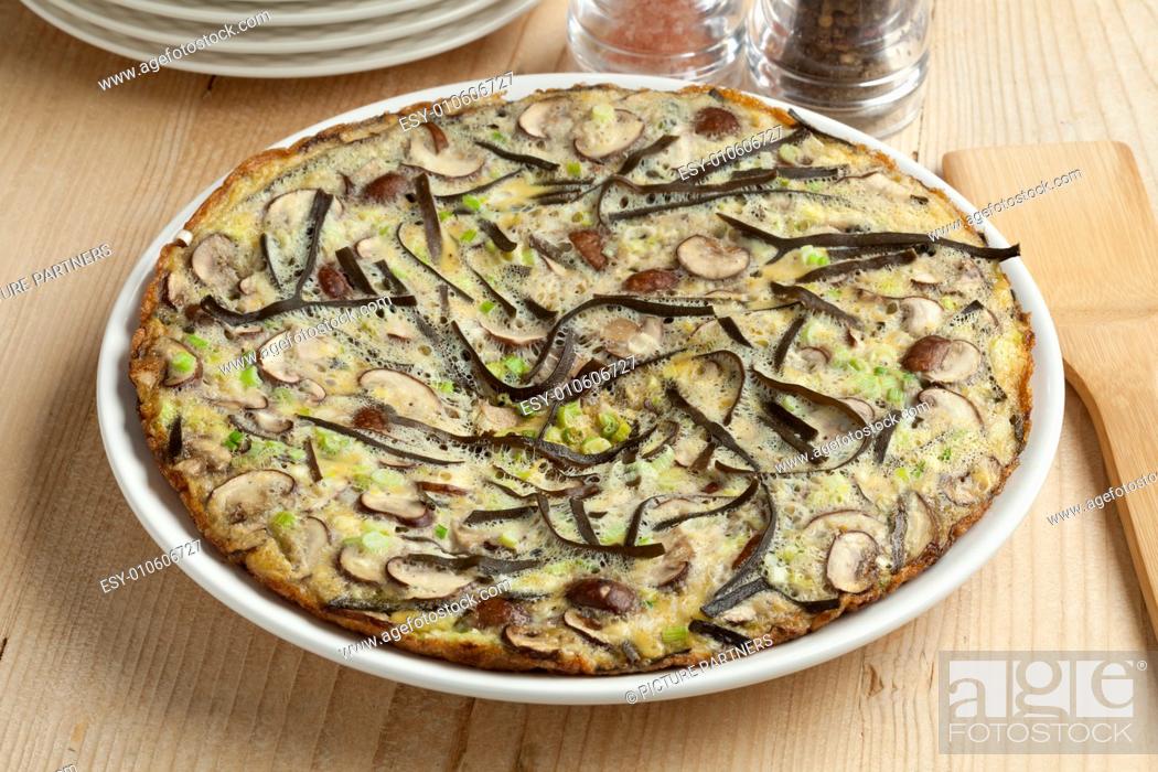 Stock Photo: Omelet with sea spaghetti, mushrooms and spring onions.