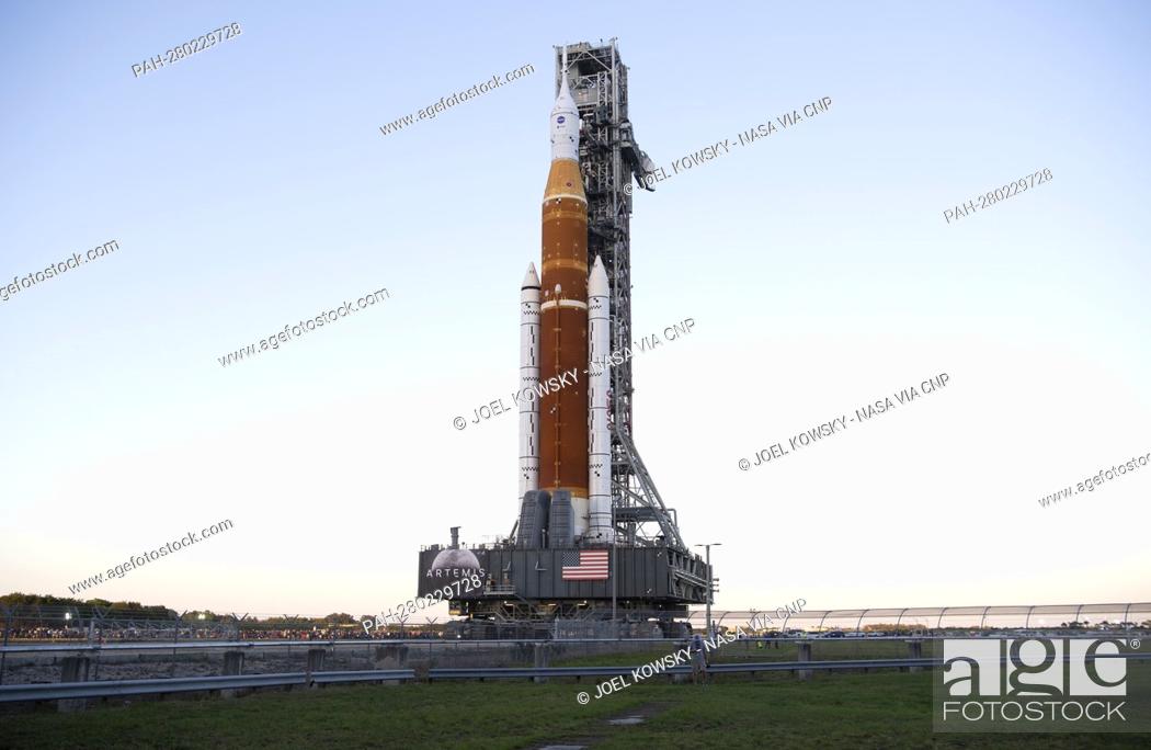 Stock Photo: NASA’s Space Launch System (SLS) rocket with the Orion spacecraft aboard is seen atop a mobile launcher as it rolls out of High Bay 3 of the Vehicle Assembly.