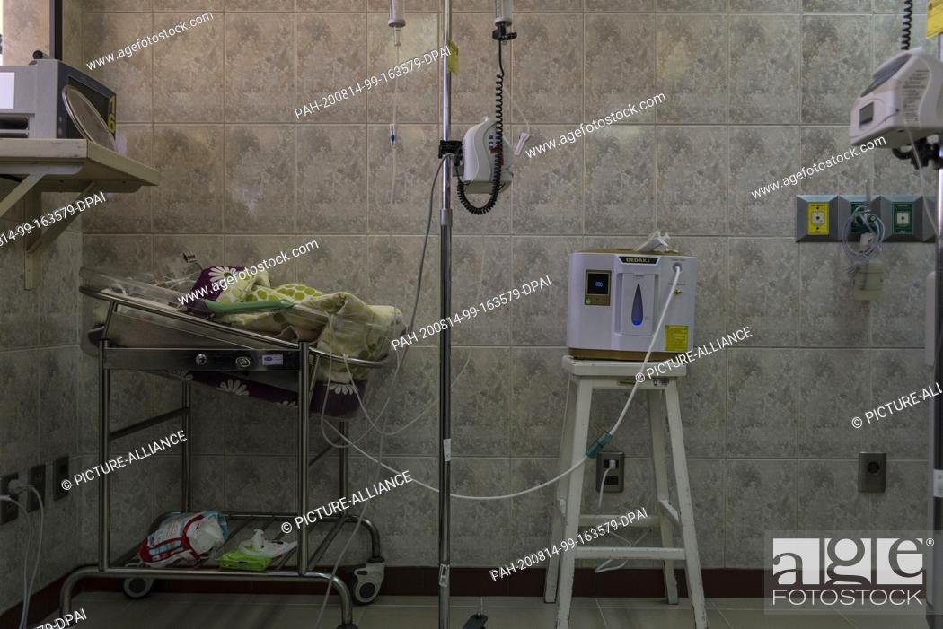 Stock Photo: 13 August 2020, Bolivia, La Paz: A newborn baby with a disease receives respiratory support from a small electronic device due to the lack of oxygen in the.