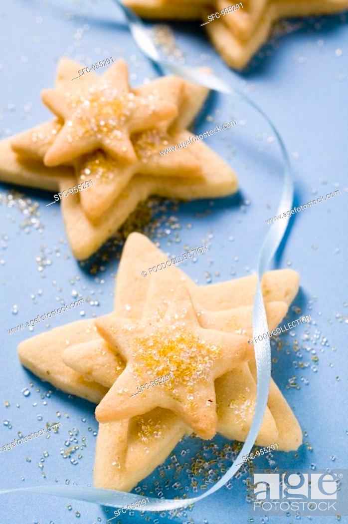 Stock Photo: Pastry stars with sugar and blue ribbon.