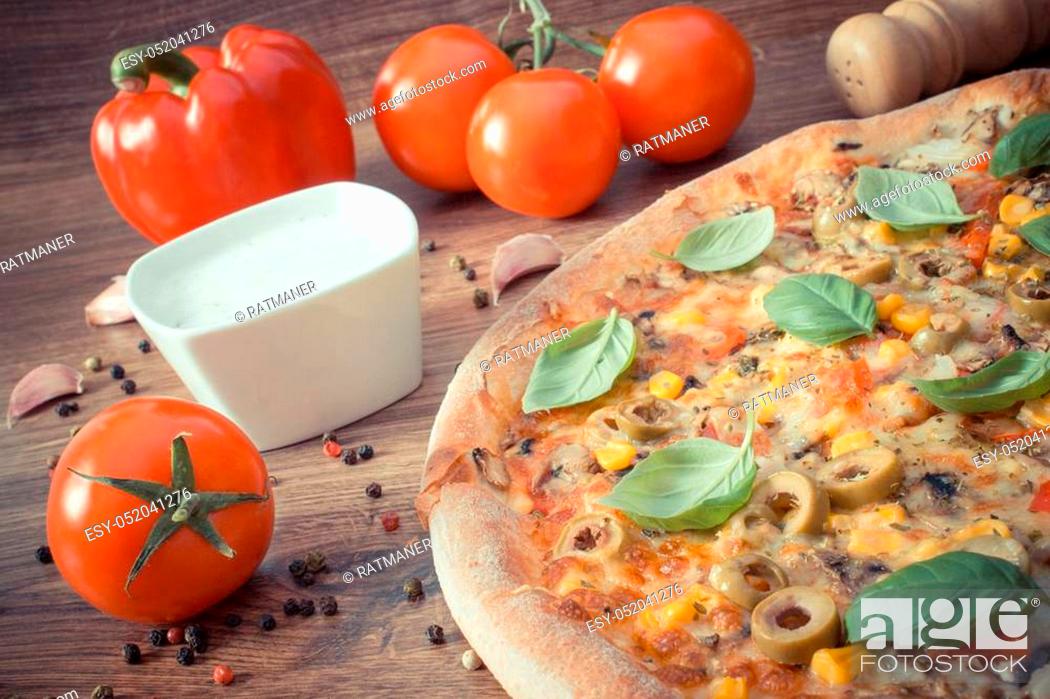 Stock Photo: Vintage photo, Fresh baked vegetarian pizza with vegetable, ingredients and spices on rustic wooden background, italian cuisine, fast food.