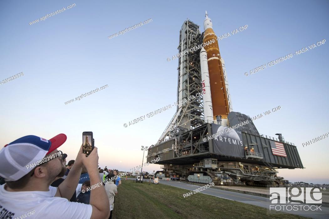 Stock Photo: Invited guests and NASA employees take photos as NASA’s Space Launch System (SLS) rocket with the Orion spacecraft aboard is rolled out of High Bay 3 of the.