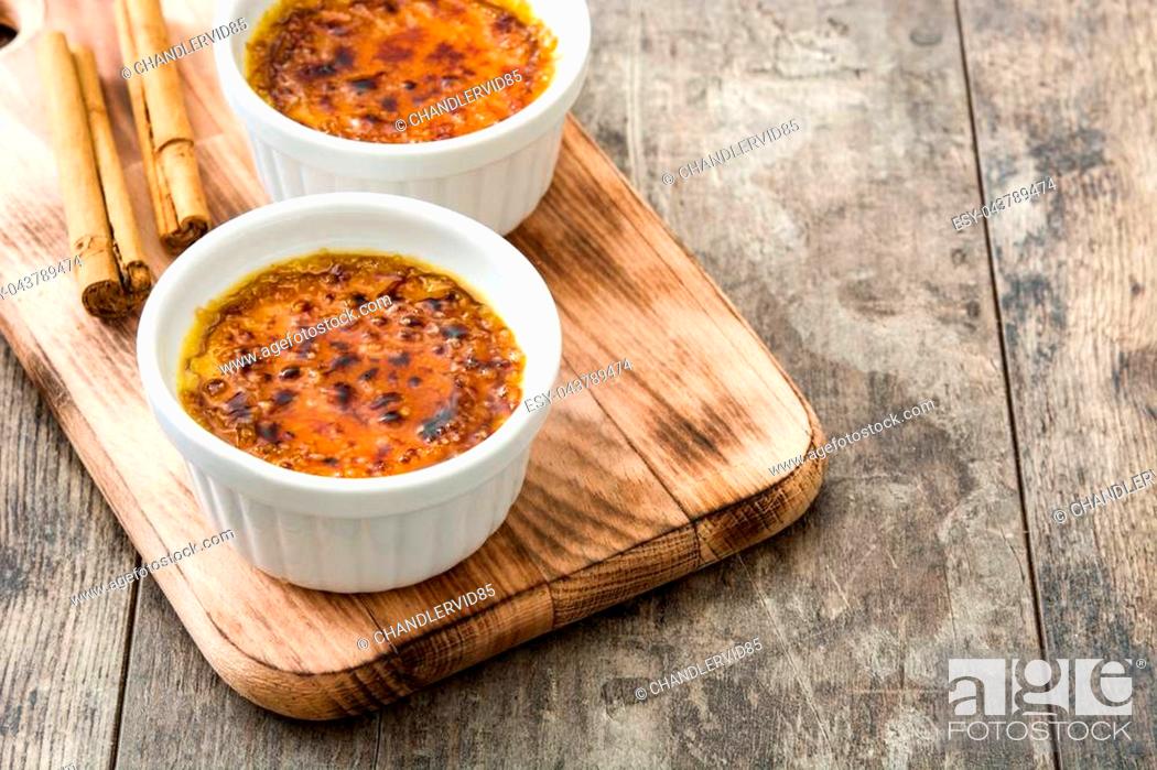 Stock Photo: Traditional French creme brulee dessert with caramelized sugar on top, on wooden table.