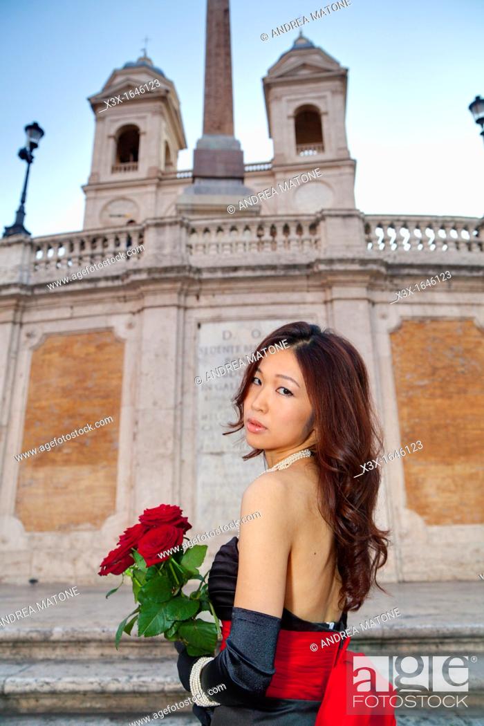 Stock Photo: Asian girl with red roses on the stairs of Piazza di Spagna Rome Italy.