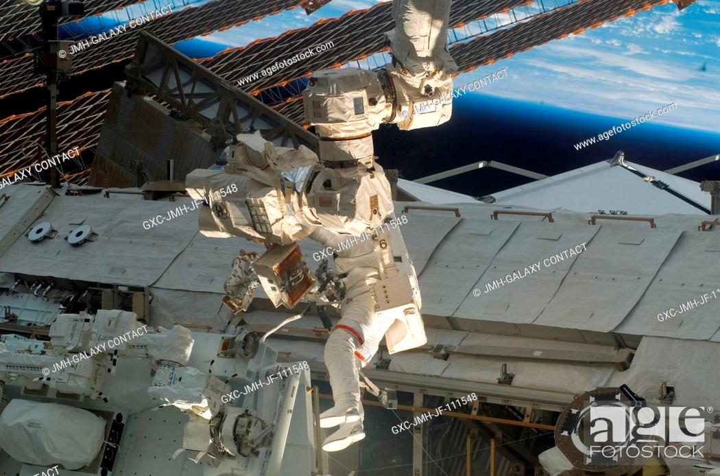 Stock Photo: Astronaut Rick Linnehan, STS-123 mission specialist, participates in the mission's first scheduled session of extravehicular activity (EVA) as construction and.
