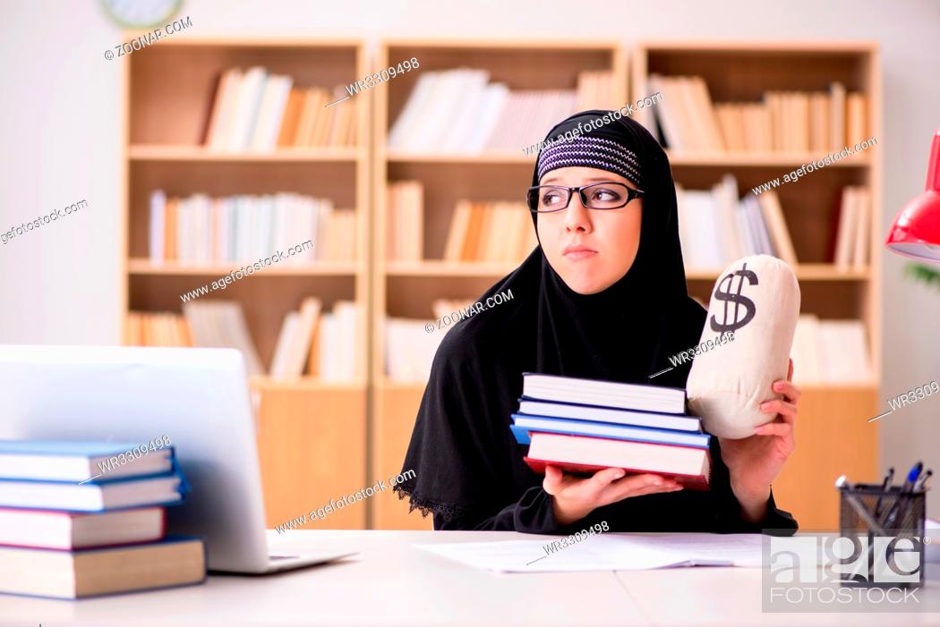 Stock Photo: Muslim girl in hijab studying preparing for exams.