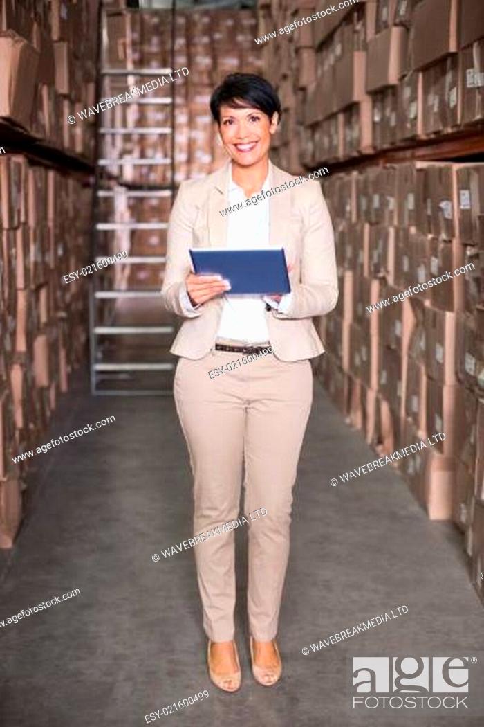 Stock Photo: Pretty warehouse manager using tablet pc.