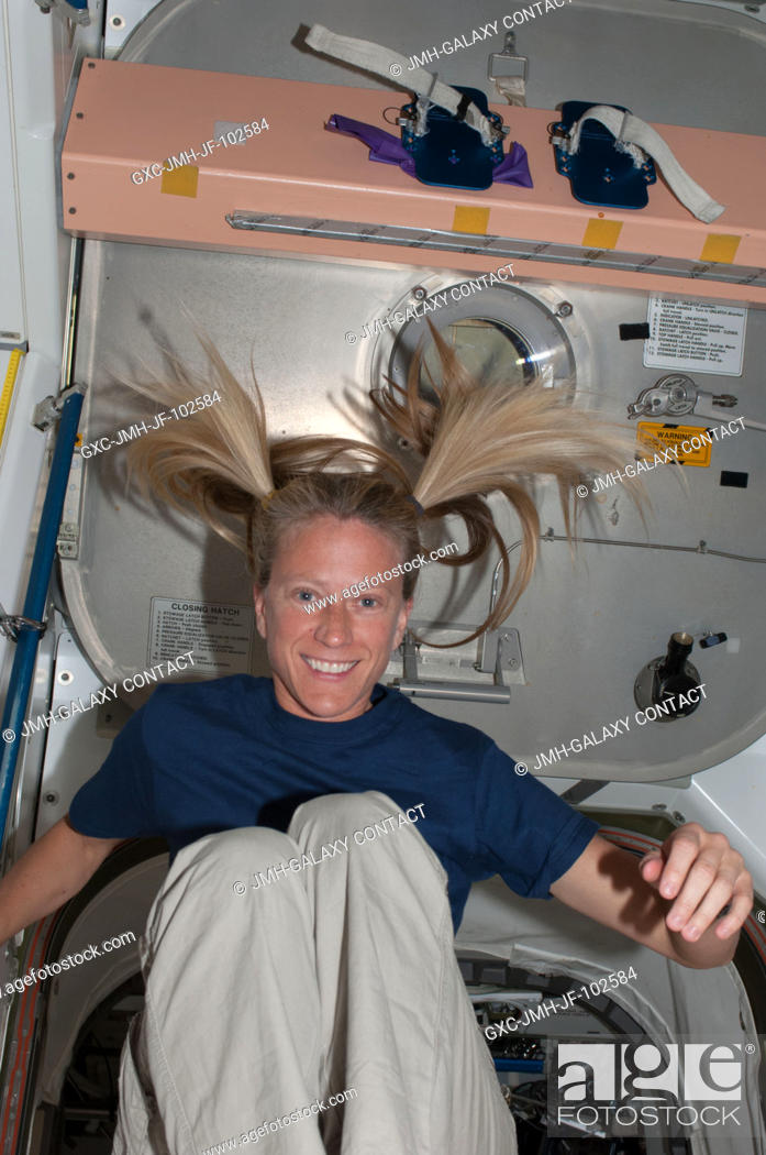 Stock Photo: It's recess time for a floating astronaut Karen Nyberg, Expedition 36 flight engineer, in the Unity node aboard the International Space Station.